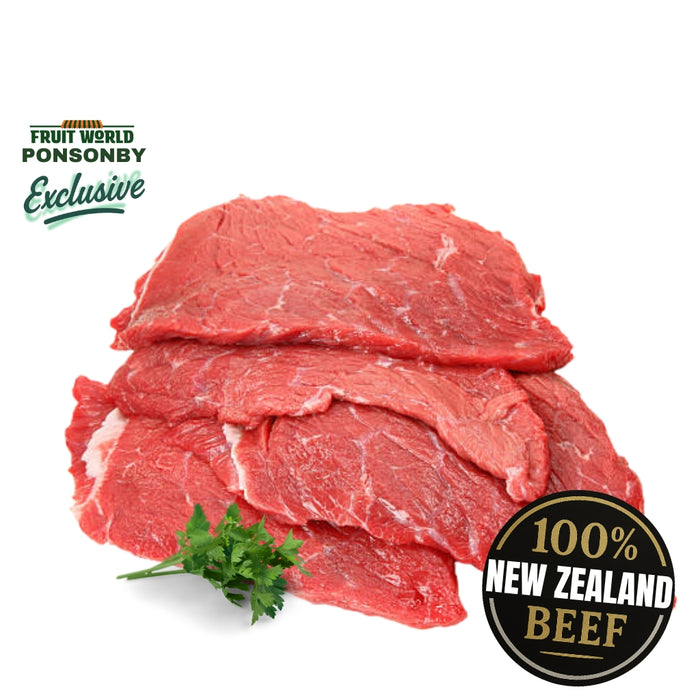 Raw beef slices with '100% New Zealand Beef' label and 'Fruit World Ponsonby' branding on a white background.