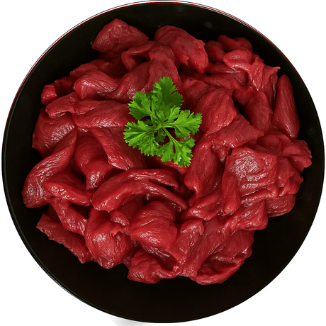 Prime Range Fresh Raw Beef Stir Fry on a black plate with a sprig of parsley