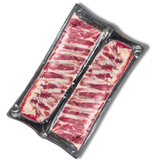 Packaged raw Pork ribs on a white background